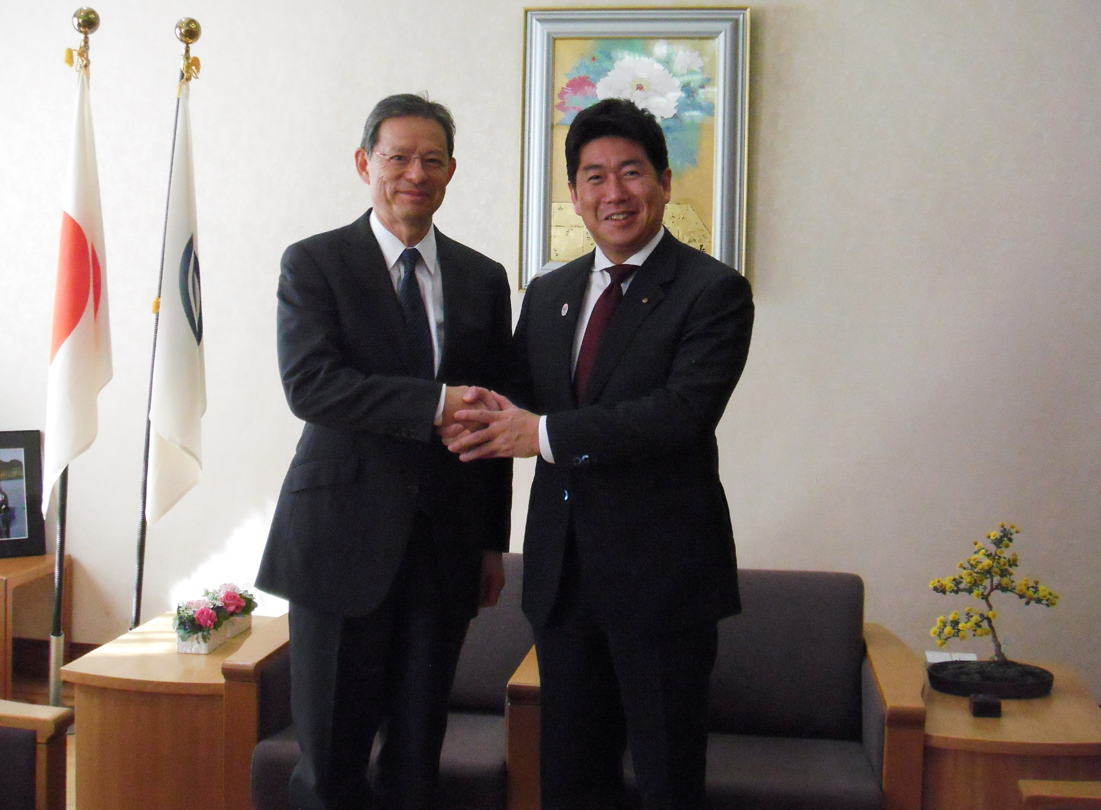 末吉竹二郎氏と握手を交わす市長
