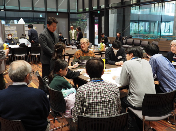 写真1：各グループでの議論に聞き入る様子