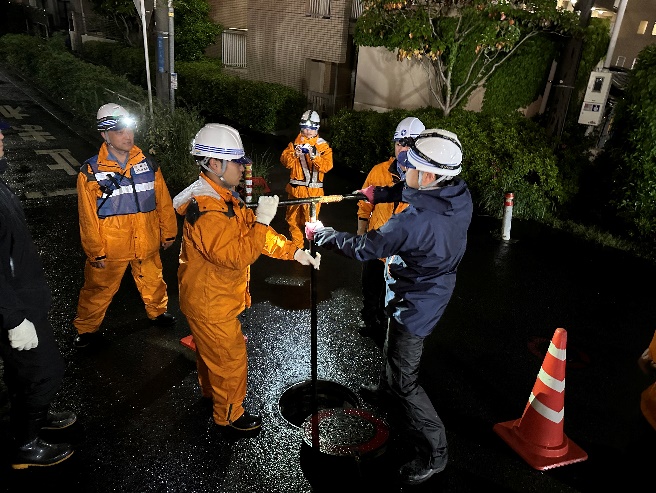 複数人で仮排水所の操作をする様子。重い。